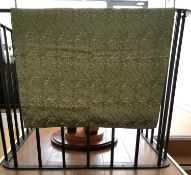 A pale green linen backed textile wall hanging with embroidered Arabic text, possibly verses from