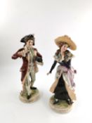 A pair of 18th century continental porcelain figures, marked to the base. (Damage to the neck of one