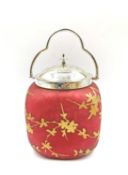 A pink satin glass biscuit barrel with gilded prunus blossom decoration and a silver plated collar