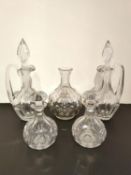 A collection of cut glass decanters to include a pair of jugs, a small pair of globular form, and