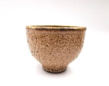 A salt-glazed stoneware studio pottery bowl on a narrow foot with makers mark to the base. H.8.5