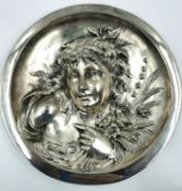 An early 20th century cast metal wall plaque with an Art Nouveau style girl in relief, marked B &