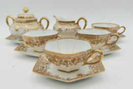 A part china tea service comprising four tea cups, six saucers, a milk jug and a sugar bowl; hand