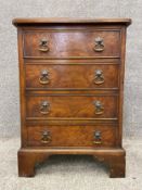 A yewwood and walnut crossbanded Georgian style chest of drawers of small size with brass handles on