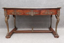 A large Empire style burr walnut and mahogany console table with a tooled leather top above three