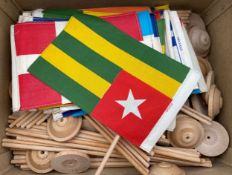 A collection of conference table flags on beech desk poles, along with a list of the countries