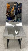 A Duffy of London Shadow chair, with a mirror polished stainless steel finish, the matt black