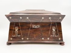 An early 19th century Regency rosewood tea caddy with mother of pearl inlay and a fitted interior,