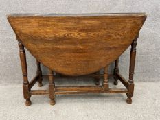 An 18th century country oak drop flap dining table with gateleg action. H.74 W.97 D.49cm.