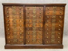 A 19th century oak haberdashery or filing chest of drawers with brass handles and label holders,