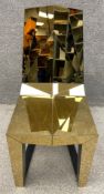 A Duffy of London Shadow chair, with a mirror polished stainless steel finish, the matt black
