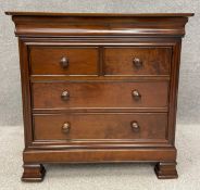 A contemporary mahogany chest of drawers by Simon Horn, the top being hinged and opening to reveal a