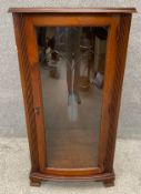 A mahogany hi-fi cabinet with and etched glass door flanked by fluted pilasters and raised on shaped