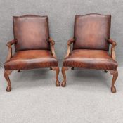 A pair of contemporary Georgian style carved oak and faux leather armchairs with fluted and