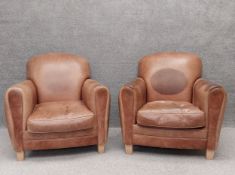 A pair of vintage style brown leather club chairs on square tapered feet. H.91 D.100cm