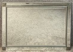 A contemporary wall mirror with bevelled plate in mirrored frame. H.74 W.104cm