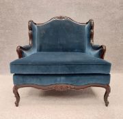 A large contemporary mahogany framed Louis XV style armchair or loveseat with carved foliate