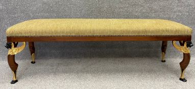 A Regency style mahogany window seat on gilt and ebonised neoclassical style griffin supports. H.