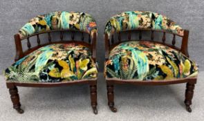 A pair of late 19th century walnut framed library tub chairs in colourful exotic bird upholstery.