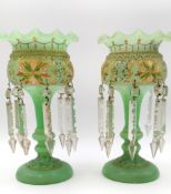 A pair of hand painted Victorian green glass mantle lustres, with gilt stylised flowers and leaves
