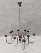 An early 20th century patinated brass ten branch chandelier. H.84 Dia.70cm