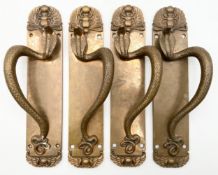 Four cast brass Egyptian revival style door handles with scarab beetle and cobra motifs. H.34 W.