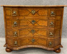An 18th century Italian walnut commode chest with a quarter veneered and crossbanded top with
