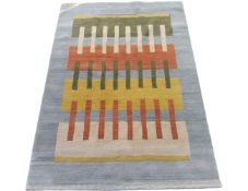 A Nepalese rug with central green, red and yellow broad stripes & thinner black, red and white