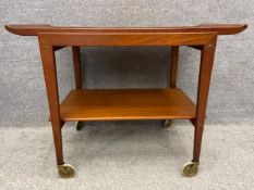 A mid-century Danish style teak trolley on casters with a detachable tray top. H.67 W.88 D.48cm.