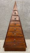 A 1980's fruitwood pyramid chest of seven graduating drawers on a pedestal base. H.121cm.