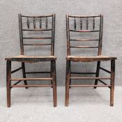 A pair of late 19th century ebonised William Morris Sussex chairs. H.86.5cm. Provenance: Acquired by