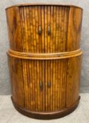 A mid-century Art Deco walnut demi-lune cocktail cabinet with tambour doors opening on to a mirrored