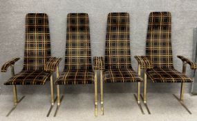A set of four vintage high-backed fabric armchairs on chrome bifurcated supports. H.125cm.