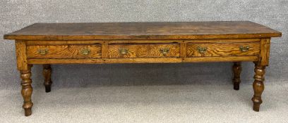 A 19th century elm farmhouse dresser base with a heavy two plank top over three frieze drawers