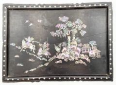 A 19th century Chinese ebonised hardwood panel with engraved mother of pearl inlay depicting a