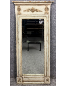 A painted and distressed French Empire style pier mirror, the frieze having a scrolling acanthus