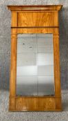 A 19th century Biedermeier satinwood pier mirror, the original plate flanked by pilasters supporting