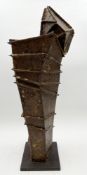 An abstract Constructivist style weathered and distressed iron sculpture on a low plinth base, by