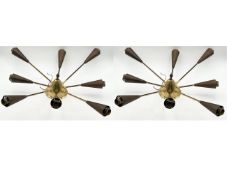 A pair of mid-century brass and sheet metal eight branch ceiling lights in the manner of Oscar
