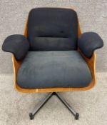 A mid-century ply swivel chair with removable original upholstered cushions, on a chrome support, in