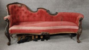 A Victorian carved walnut chaise longue with scrolling foliate motifs, original buttoned corduroy