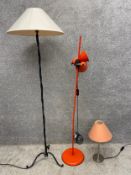 Three lamps to include a cast iron floor lamp with a twisted stem on tripod supports with shade, a