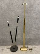 A mid-century French brass and ebonised floor lamp with two branches on a turned three footed