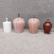 A pair of contemporary terracotta lamps of classical form with applied flowers and leaves, along
