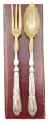 An embossed white metal and horn salad serving fork and spoon with indistinct stamps to the handles.