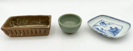 A contemporary Chinese terracotta footed tea bowl with a celadon crackle glaze and incised marks,