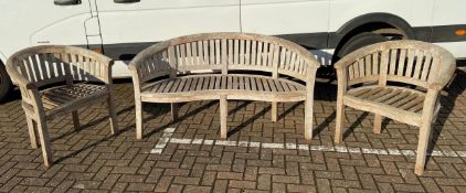 A curved teak garden bench along with two matching armchairs. H.86 W.157cm (largest).