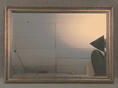A large contemporary gilt silver mirror with a moulded frame surrounding a bevelled plate. H.92 W.