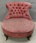 A Victorian walnut buttoned back bedroom chair on turned and carved supports to the front and square