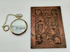 A simulated copper King of Hearts embossed metal wall hanging plaque, along with a brass oversized